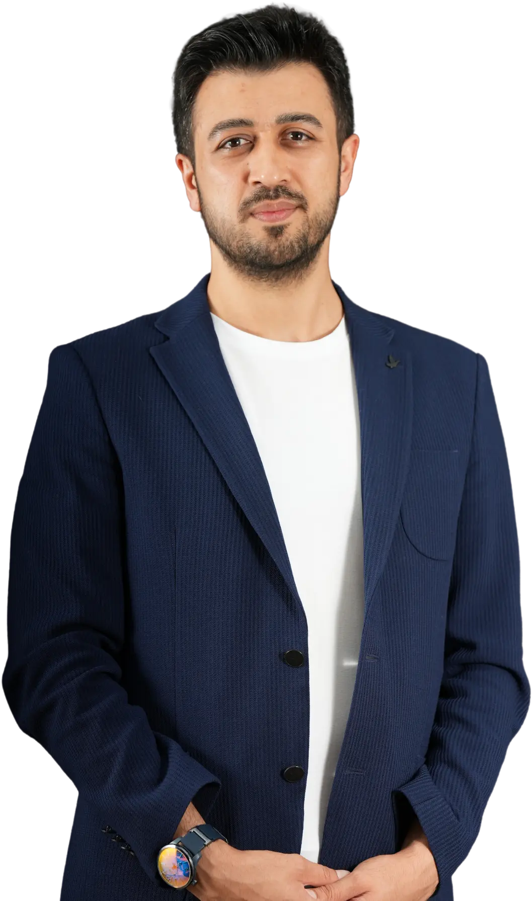 Assoc. Prof. Dr. Nesrettin Fatih Turgut standing confidently, wearing a navy blue blazer and white t-shirt, looking at the camera.